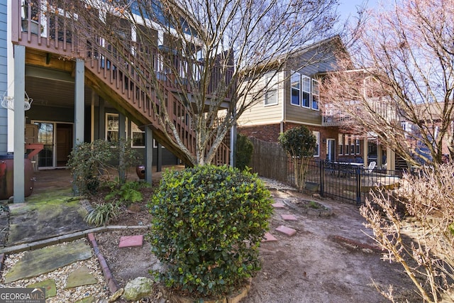 exterior space featuring stairway, fence, and a patio