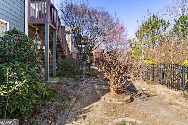 view of yard featuring stairway and fence