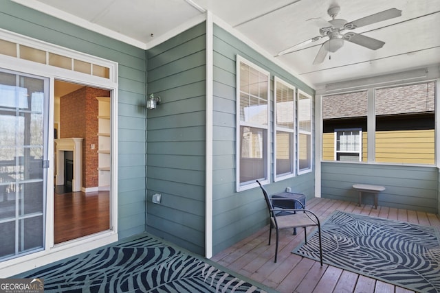 exterior space with ceiling fan and a porch