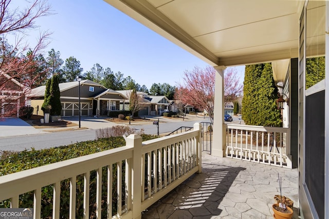 balcony featuring covered porch and a residential view