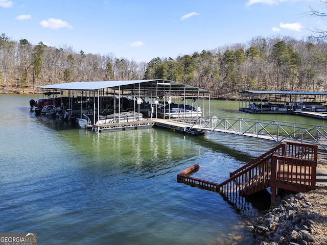 view of dock featuring a water view and a view of trees