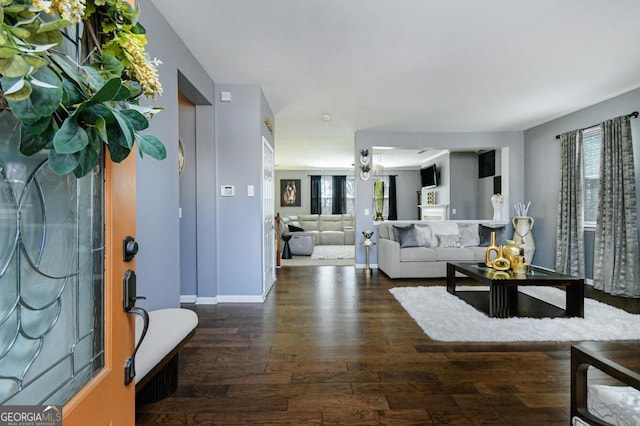 living room featuring dark wood-type flooring and baseboards