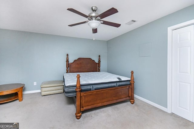 bedroom with light carpet, a ceiling fan, visible vents, and baseboards