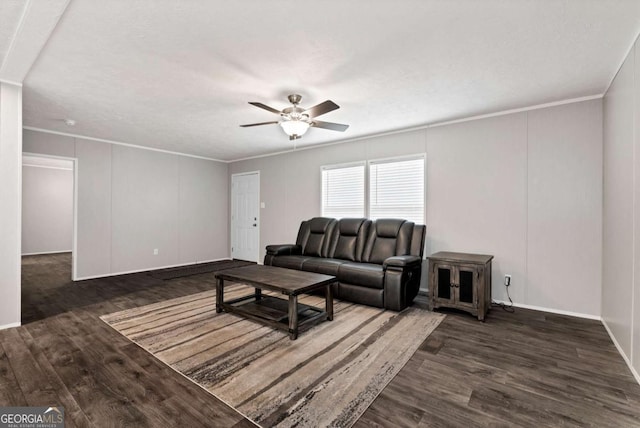 living area featuring ceiling fan, crown molding, and wood finished floors