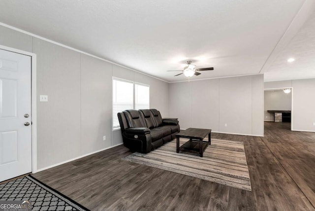 living room featuring crown molding, a ceiling fan, and wood finished floors