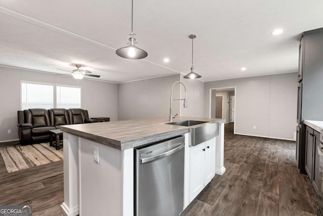 kitchen featuring an island with sink, dark wood-style floors, decorative light fixtures, stainless steel dishwasher, and a sink