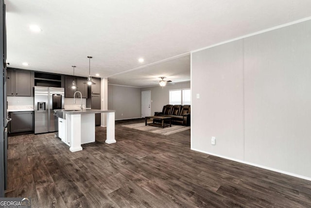 kitchen with ceiling fan, dark wood-style flooring, open floor plan, stainless steel refrigerator with ice dispenser, and open shelves