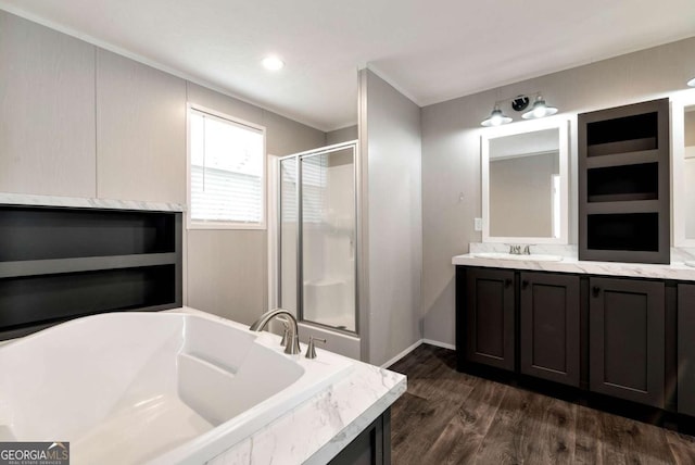 full bathroom featuring vanity, wood finished floors, a shower stall, and a bath