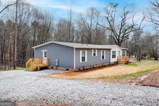 view of property exterior with crawl space and a deck