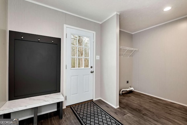 interior space with crown molding, baseboards, and wood finished floors