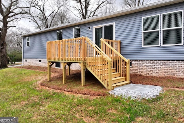 exterior space with stairway, crawl space, a lawn, and a deck