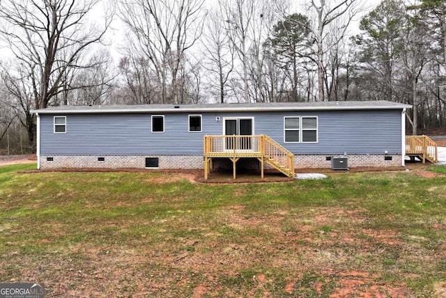 back of house with crawl space, a lawn, cooling unit, and a wooden deck