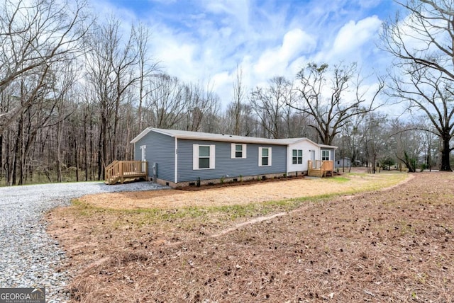 manufactured / mobile home with crawl space and a wooden deck