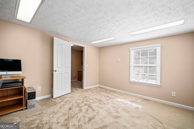 interior space with baseboards, a textured ceiling, and carpet flooring