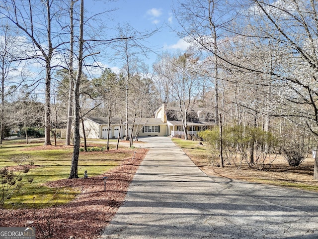 view of property's community with a yard and driveway