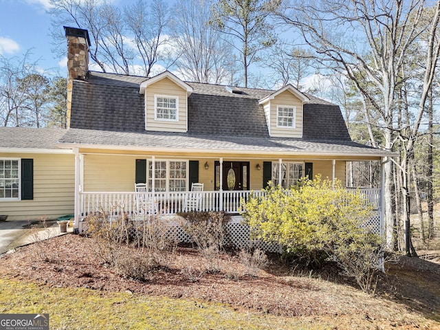 view of front facade with a porch and a shingled roof