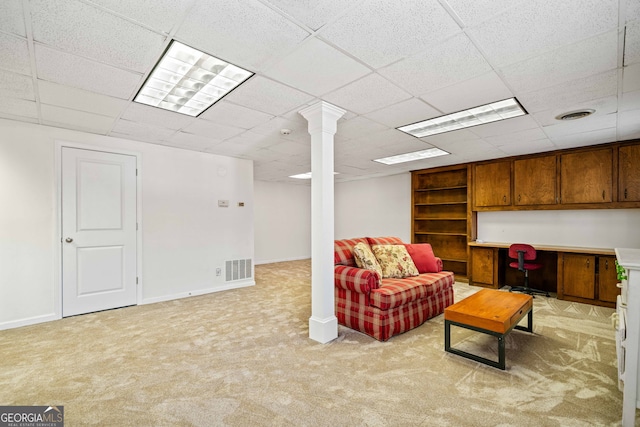 sitting room with light carpet, built in desk, visible vents, and baseboards