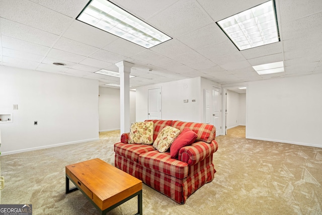 living room featuring a drop ceiling, light carpet, baseboards, and visible vents