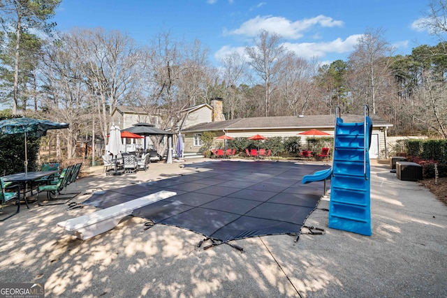 view of pool with outdoor dining space, a gazebo, central air condition unit, and a patio area