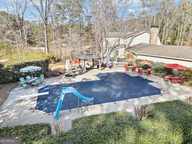 view of pool featuring a covered pool, a gazebo, and a patio area