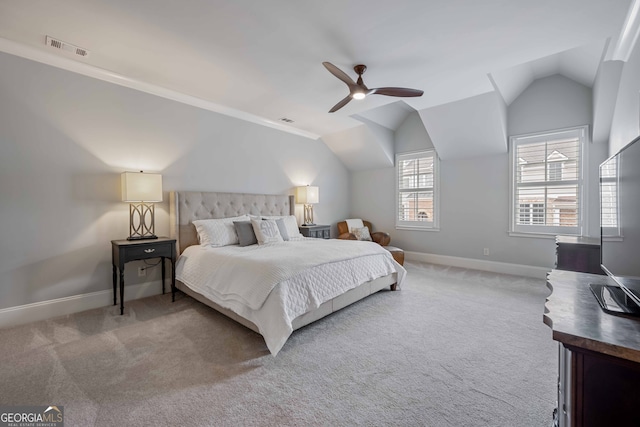 carpeted bedroom featuring baseboards, lofted ceiling, and visible vents