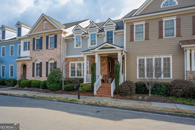 townhome / multi-family property with brick siding