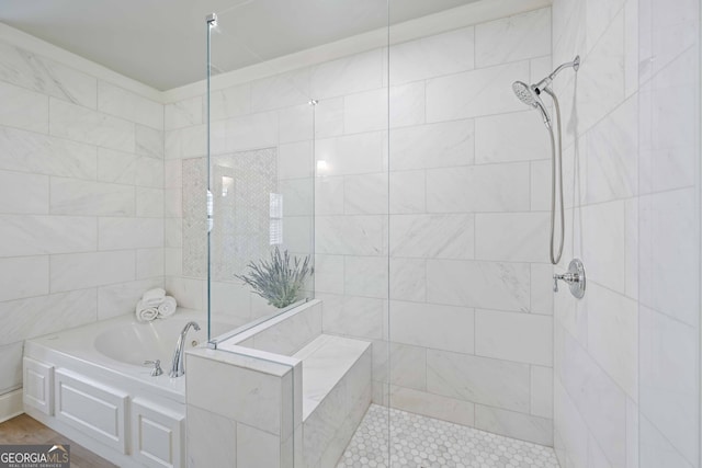 bathroom featuring a garden tub and tiled shower