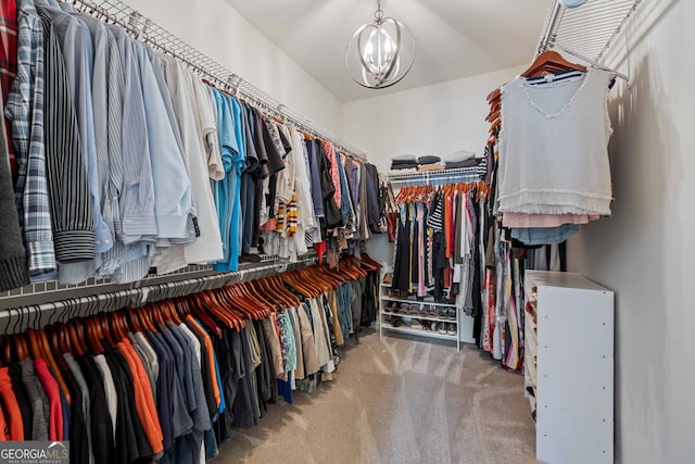 spacious closet featuring a chandelier and carpet floors