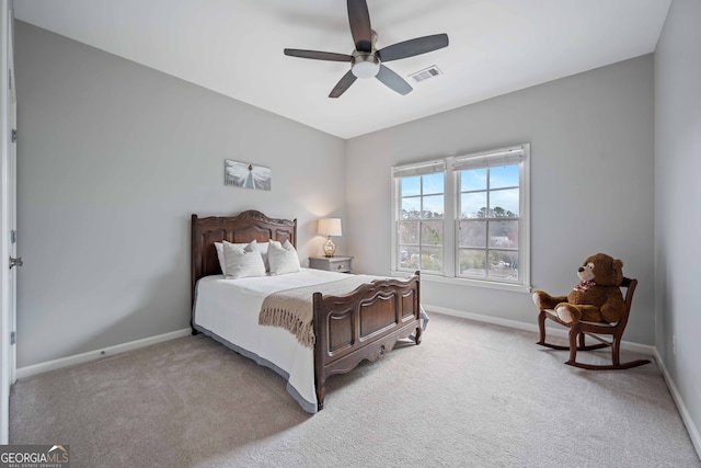 bedroom featuring visible vents, light colored carpet, baseboards, and ceiling fan