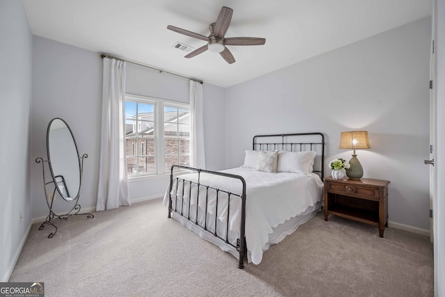 carpeted bedroom featuring visible vents, baseboards, and a ceiling fan