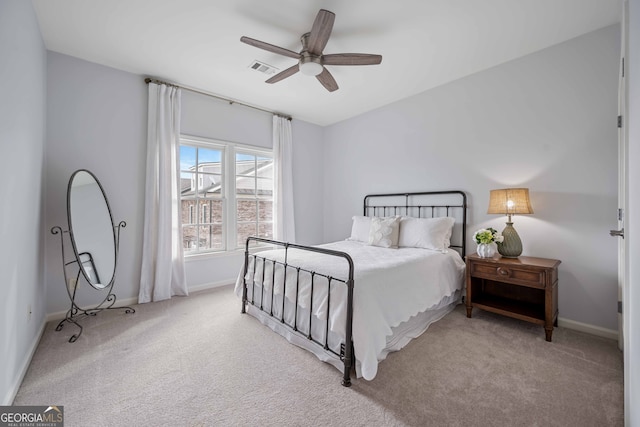 bedroom featuring visible vents, baseboards, a ceiling fan, and carpet