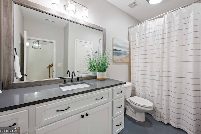 bathroom featuring a shower with shower curtain, visible vents, toilet, and vanity