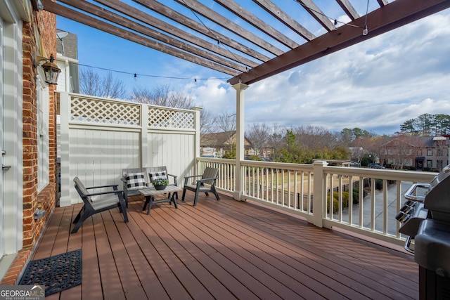 wooden deck featuring a grill and a pergola