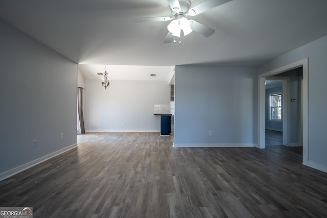 unfurnished living room featuring visible vents, dark wood finished floors, baseboards, and ceiling fan with notable chandelier