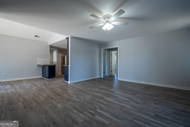 unfurnished living room featuring a ceiling fan, dark wood-style flooring, visible vents, and baseboards