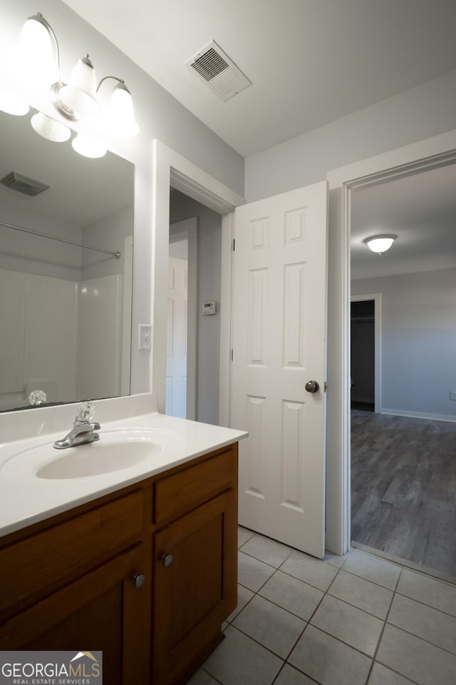 bathroom with vanity, visible vents, and tile patterned floors