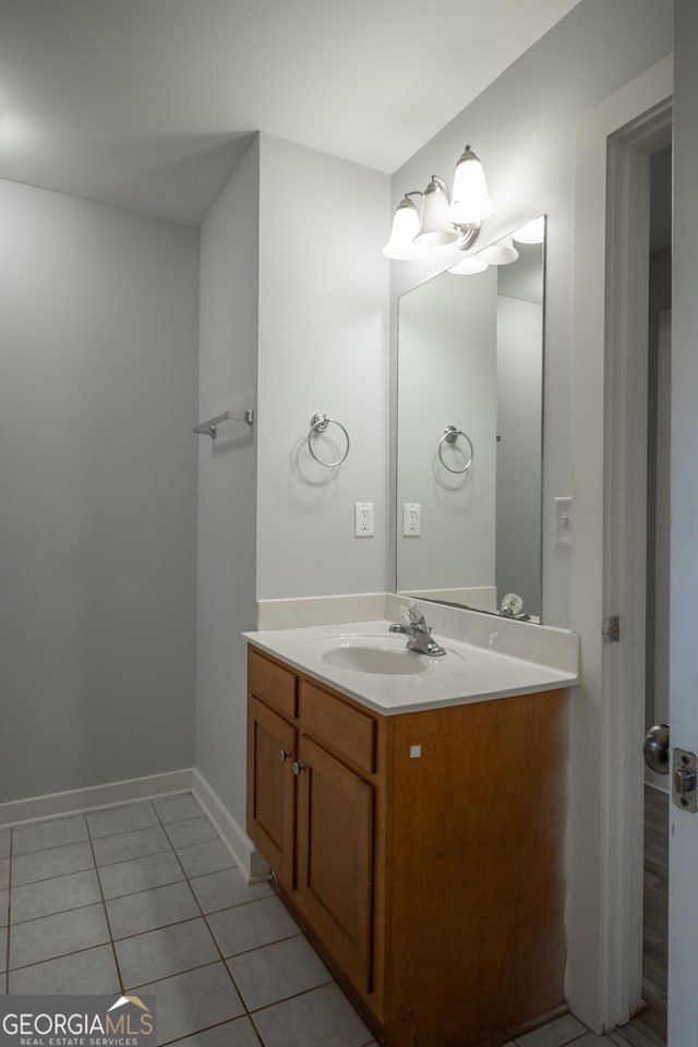 bathroom featuring baseboards, vanity, and tile patterned floors