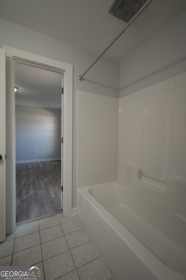 full bathroom with baseboards, shower / washtub combination, visible vents, and tile patterned floors