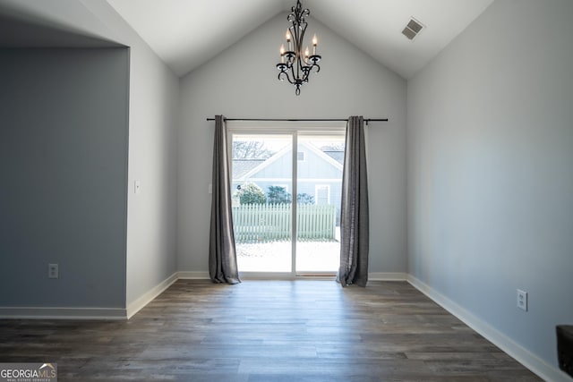 unfurnished dining area with baseboards, a notable chandelier, visible vents, and dark wood-style flooring