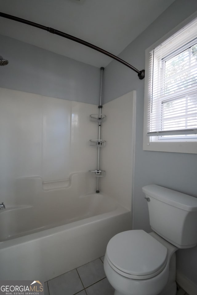 full bathroom with toilet, tile patterned flooring, and washtub / shower combination