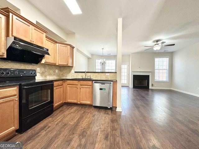 kitchen featuring under cabinet range hood, a fireplace, black electric range, stainless steel dishwasher, and tasteful backsplash