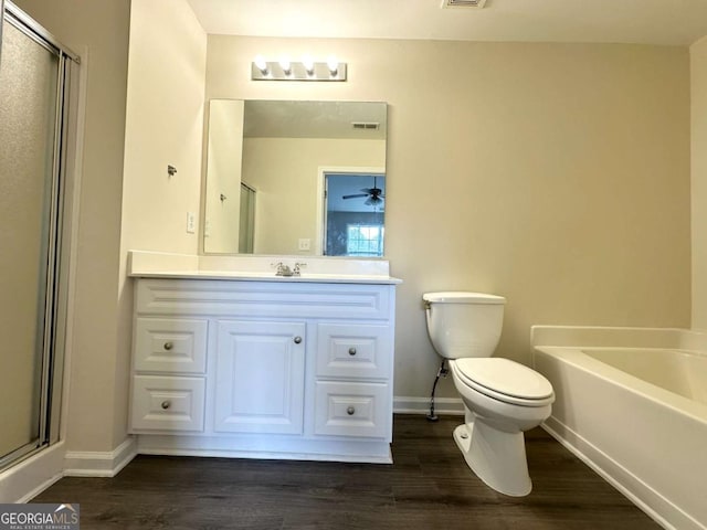 full bath with vanity, a shower stall, toilet, and wood finished floors