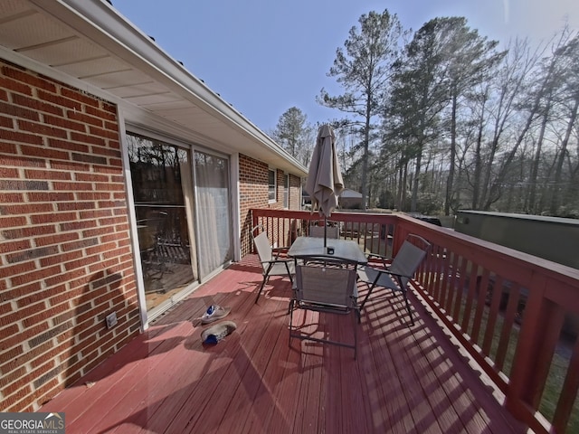 wooden terrace featuring outdoor dining space