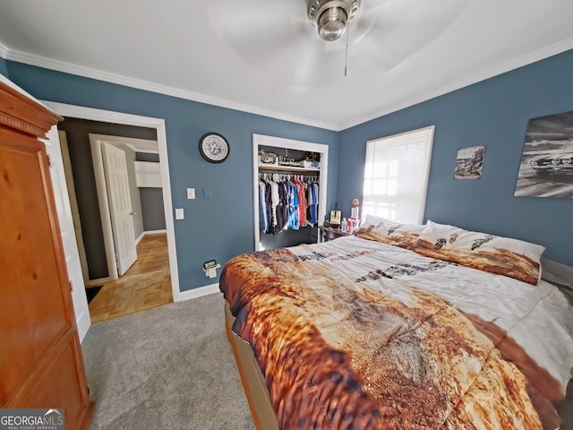 bedroom with a ceiling fan, a closet, crown molding, and baseboards