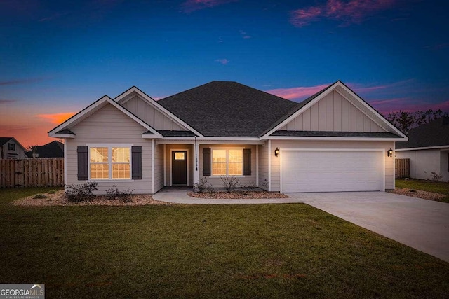 ranch-style house featuring an attached garage, driveway, fence, and board and batten siding