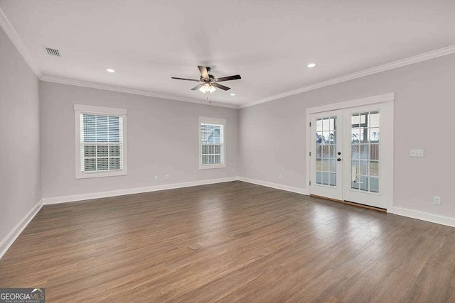 empty room featuring baseboards, visible vents, dark wood-type flooring, and french doors