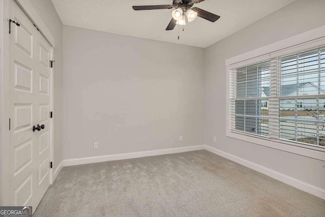 unfurnished bedroom featuring carpet floors, ceiling fan, and baseboards