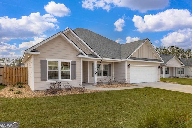 ranch-style home with an attached garage, fence, driveway, a front lawn, and board and batten siding