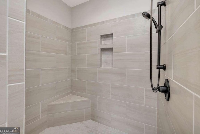 full bath with a tile shower