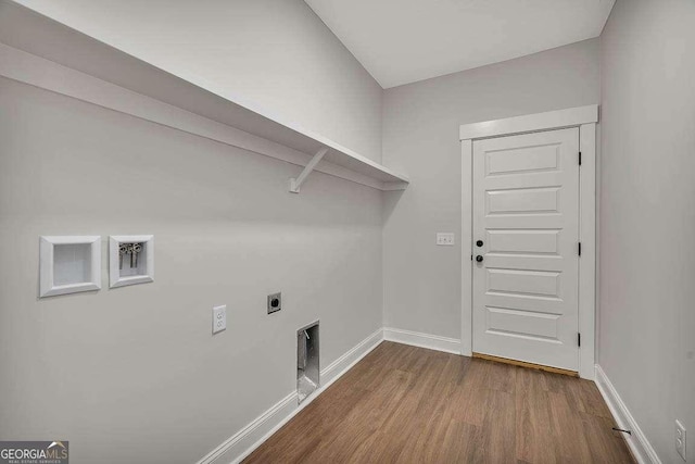 laundry area featuring dark wood-type flooring, laundry area, electric dryer hookup, and baseboards